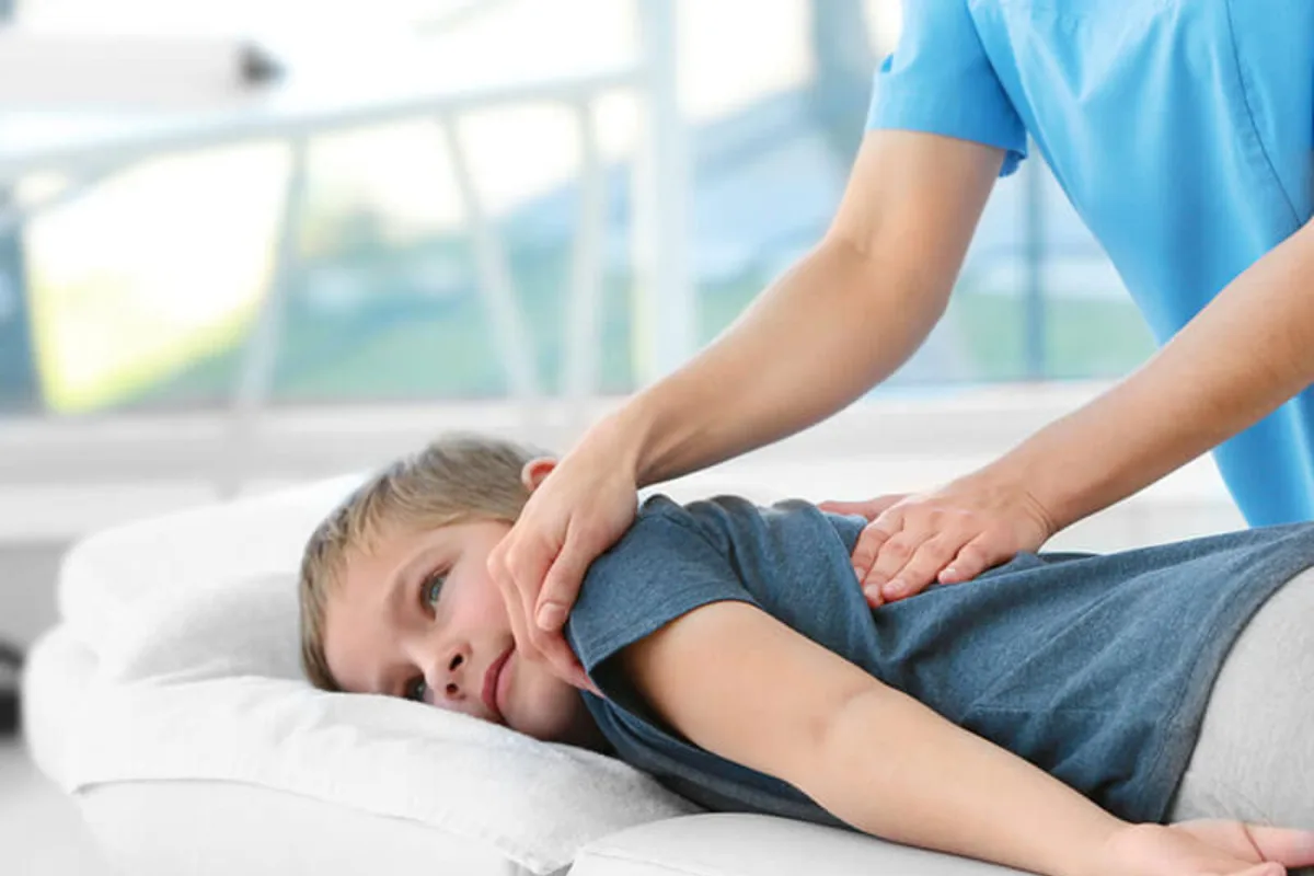 Registered massage therapist treating a child in Edmonton