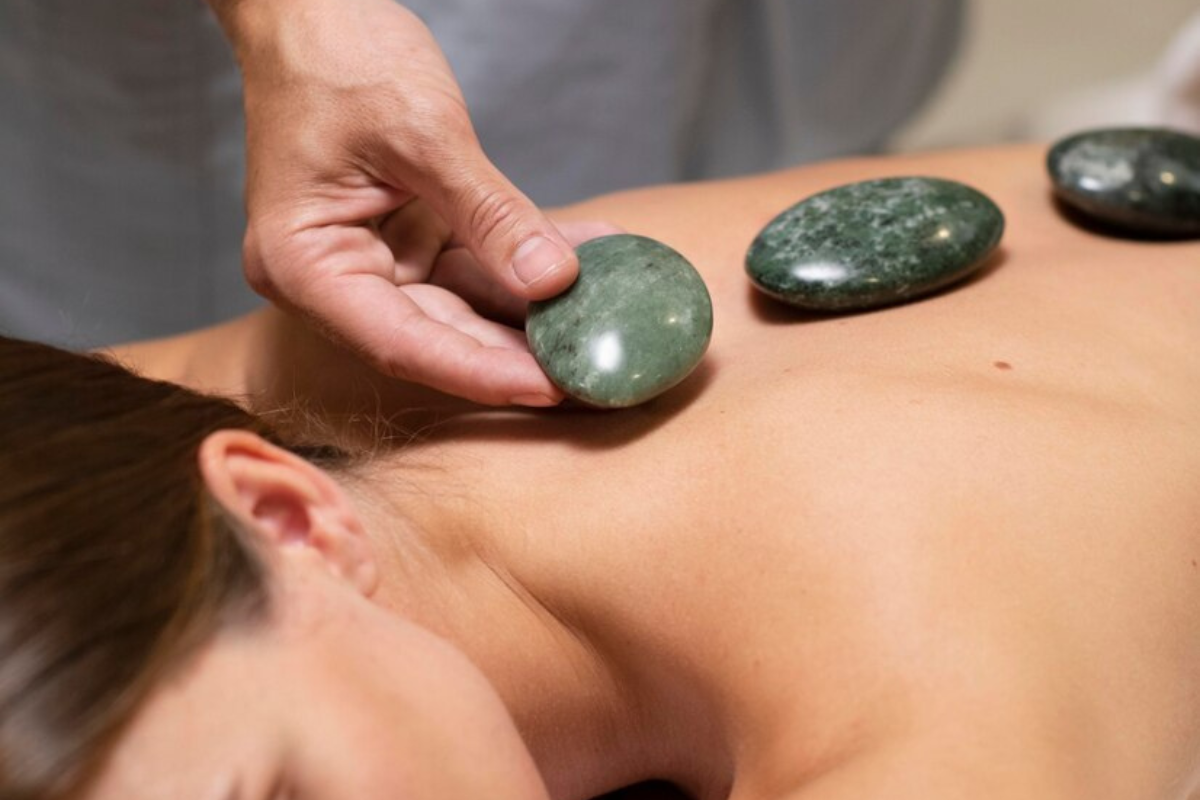 Jade stones used during stone massage therapy session in Edmonton