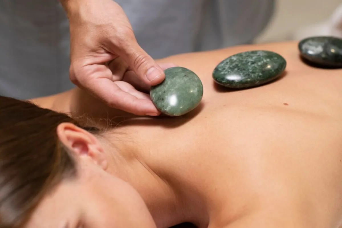 Jade stones used during stone massage therapy session in Edmonton