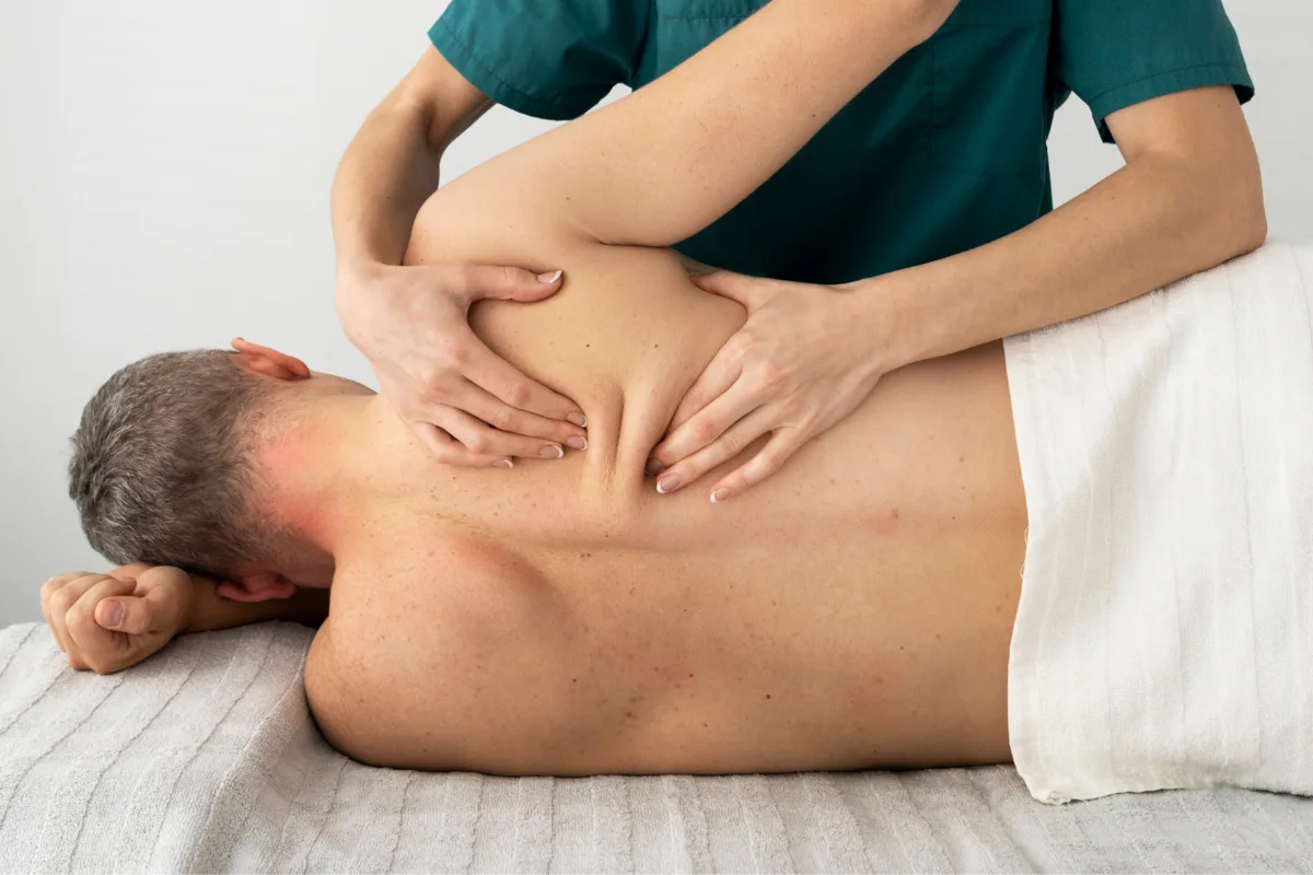 Registered massage therapist performing therapeutic massage on client at Edmonton clinic