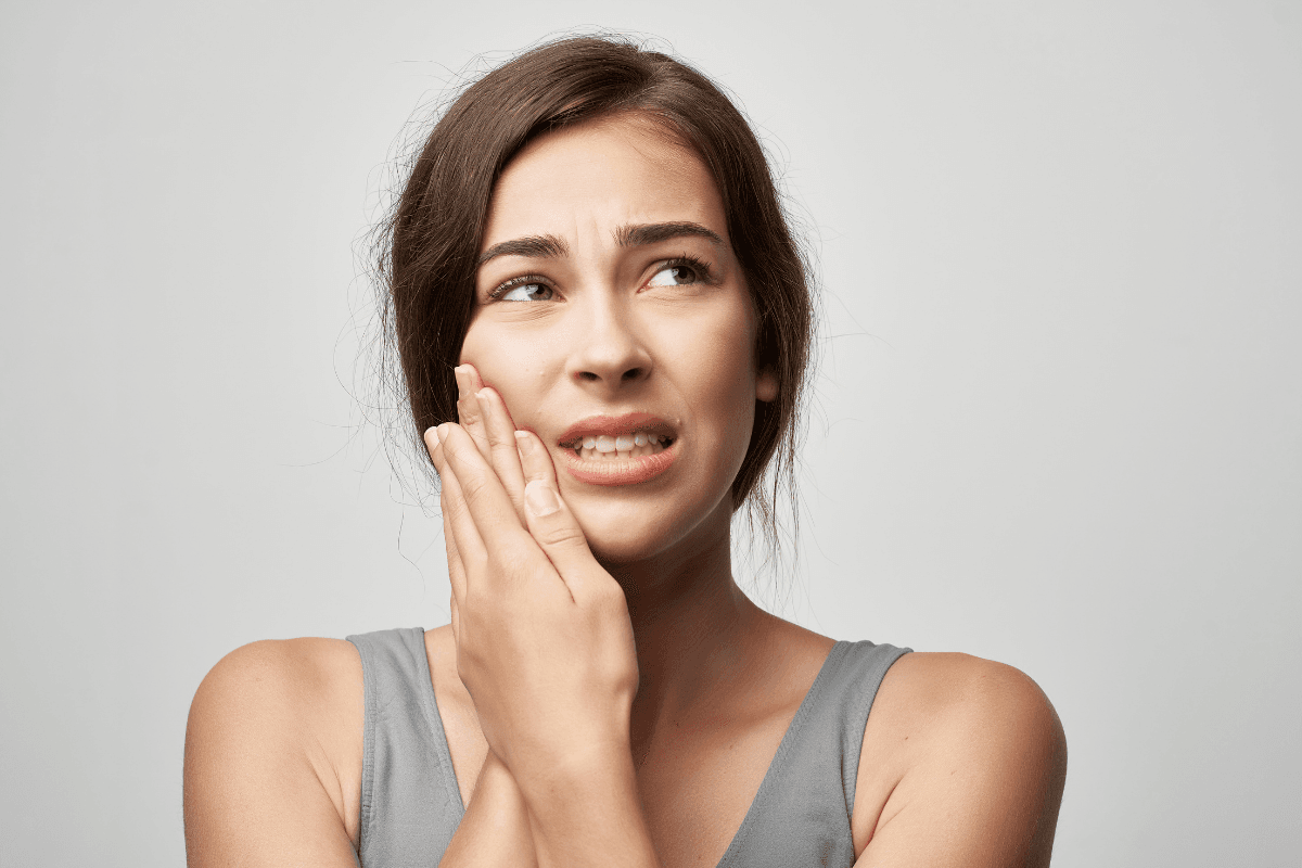 Person experiencing jaw pain and TMJ tension in Edmonton