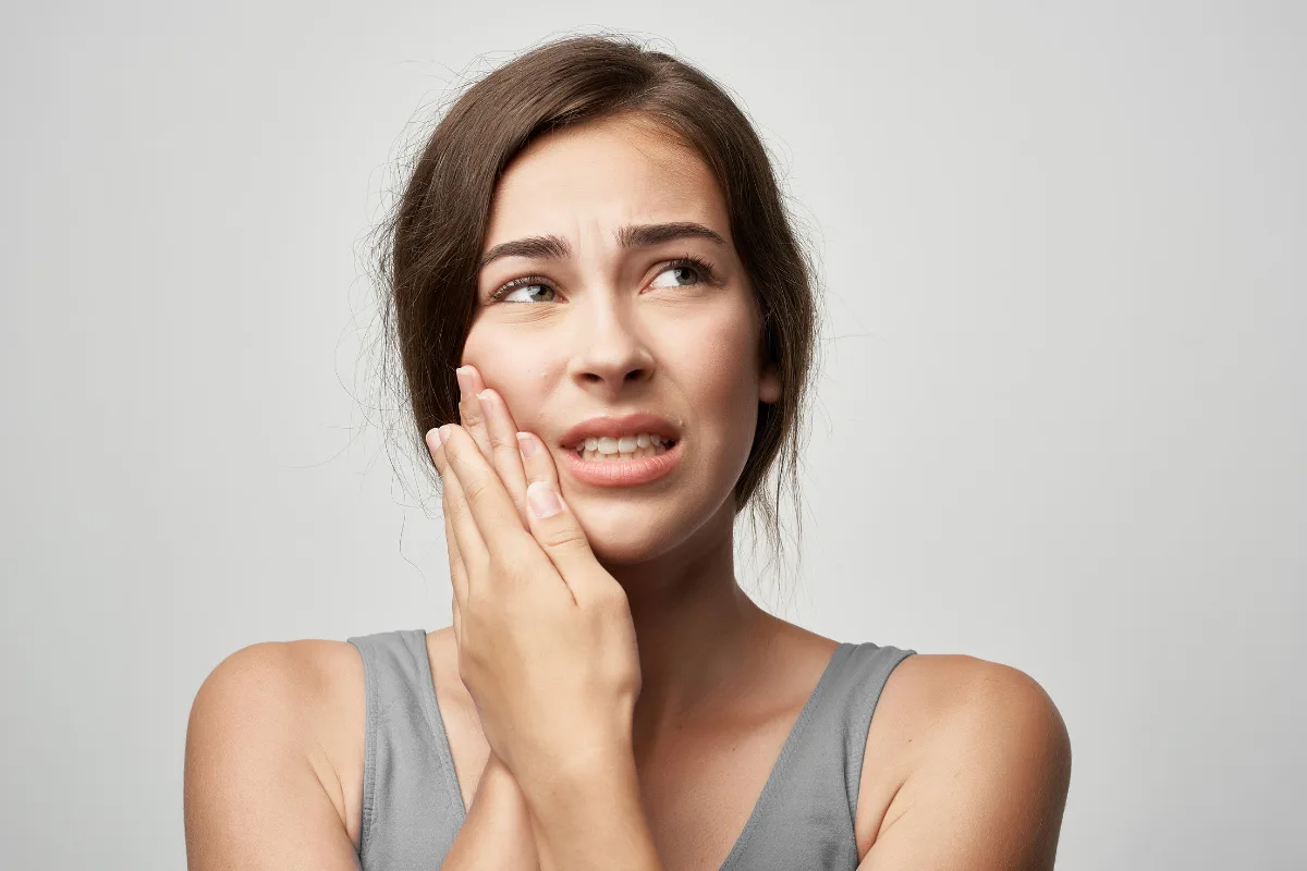 Person experiencing jaw pain and TMJ tension in Edmonton